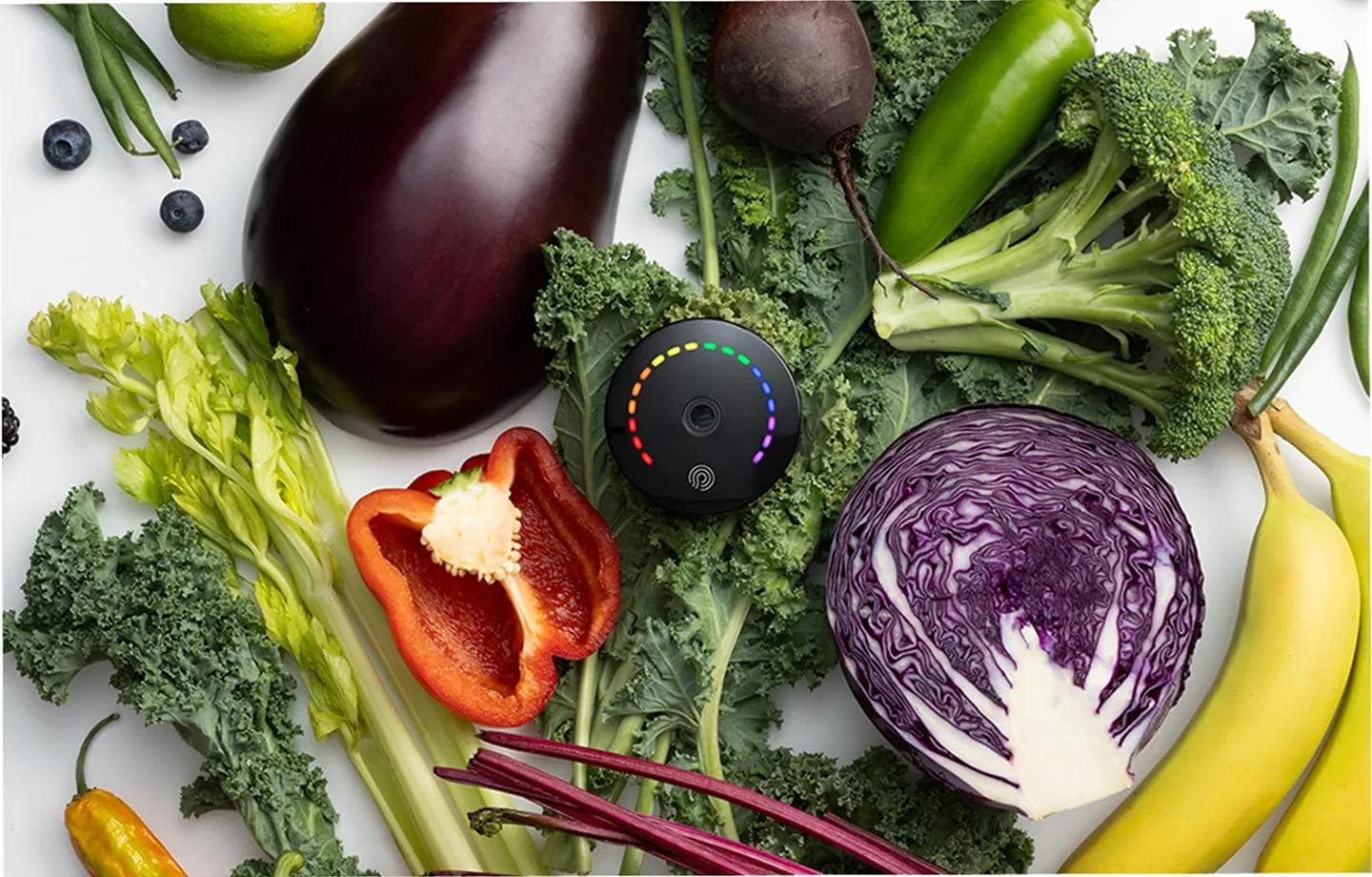 The nutrition scanner resting among colourful fruit and vegetables